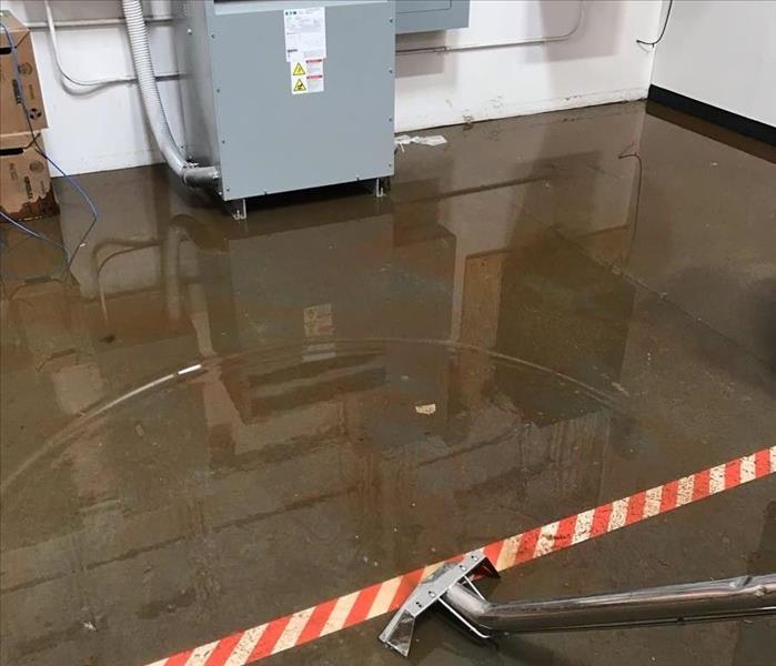 Concrete floor with an inch of water. 