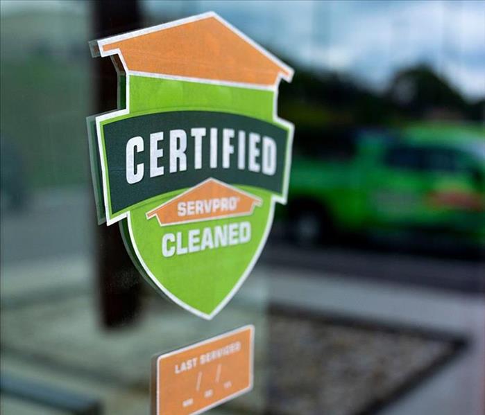 Certified: SERVPRO Cleaned logo on a window.