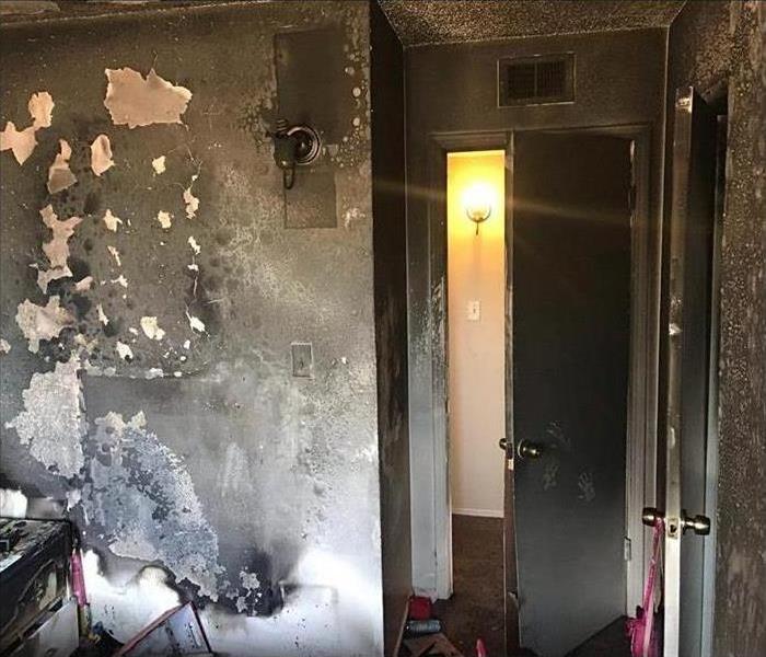 Walls and door of a room covered with smoke