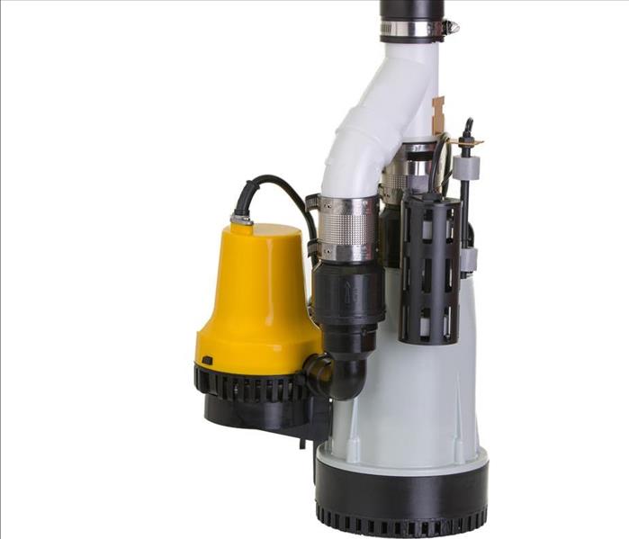 New sump pump with an attached yellow emergency backup pump in case of breakdown to be submersed in a pit to drain 